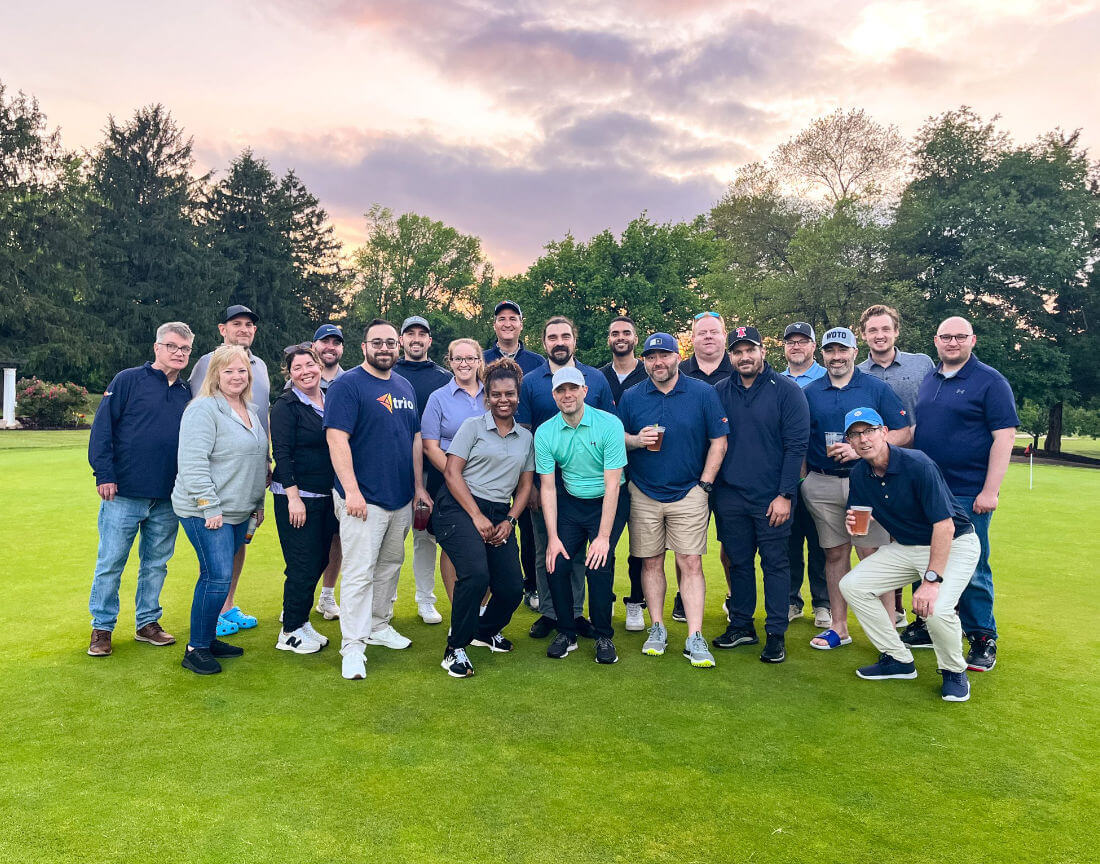 A group of Trio Capital workers on a golf course